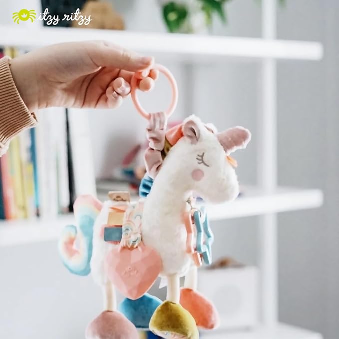Itzy Ritzy Link & Love Toy for Stroller or Car Seat – Features Textured Ribbons, Crinkle Sounds, Clinking Rings & Silicone Teether – Designed For Ages 0 Months and Up (Unicorn)